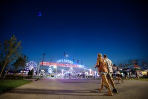A pair of fairgoers walk toward Midway at the New York State Fair.