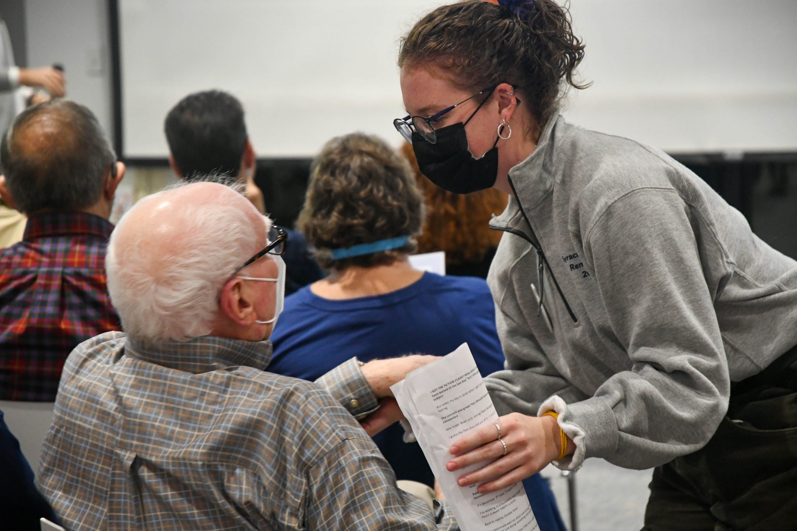 After reading Dear Dad, A Collection of Poems by Christopher Jones, Caitlyn Languille goes to embrace Jones' father in the audience.