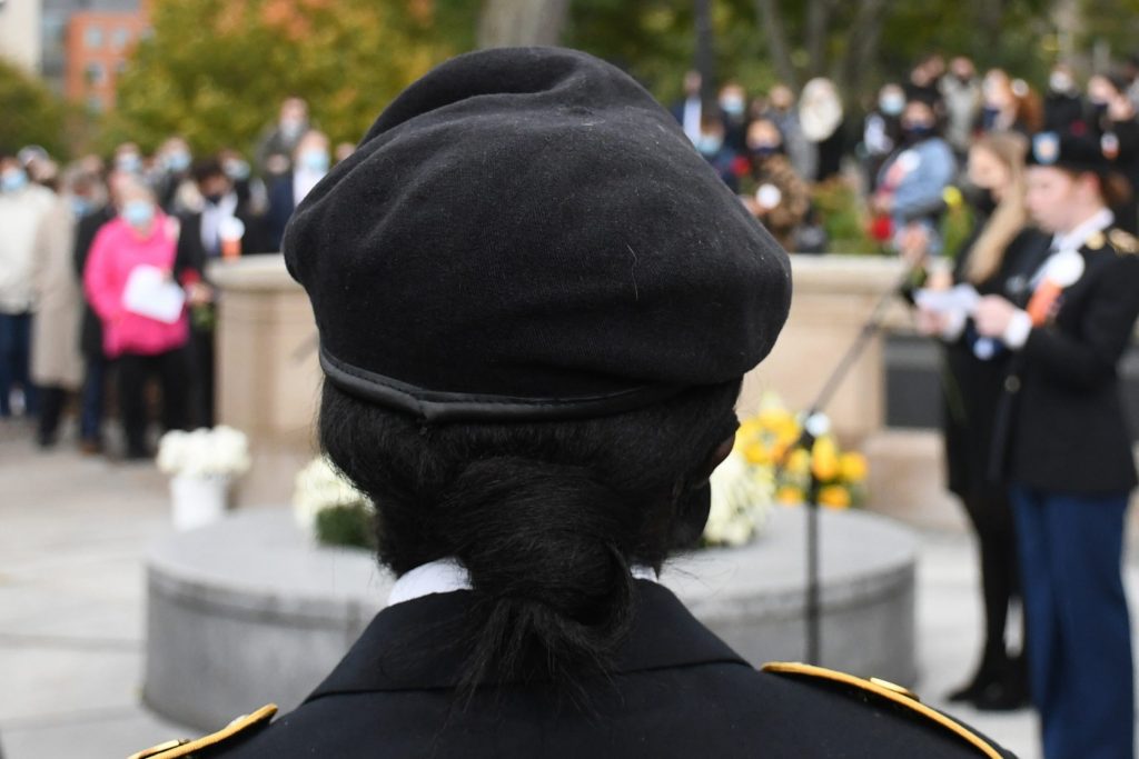 On Friday afternoon, a member of the military watches the rose laying ceremony as an ROTC student honors the life of a student killed in the bombing of Pan Am Flight 103 over Lockerbie, Scotland.