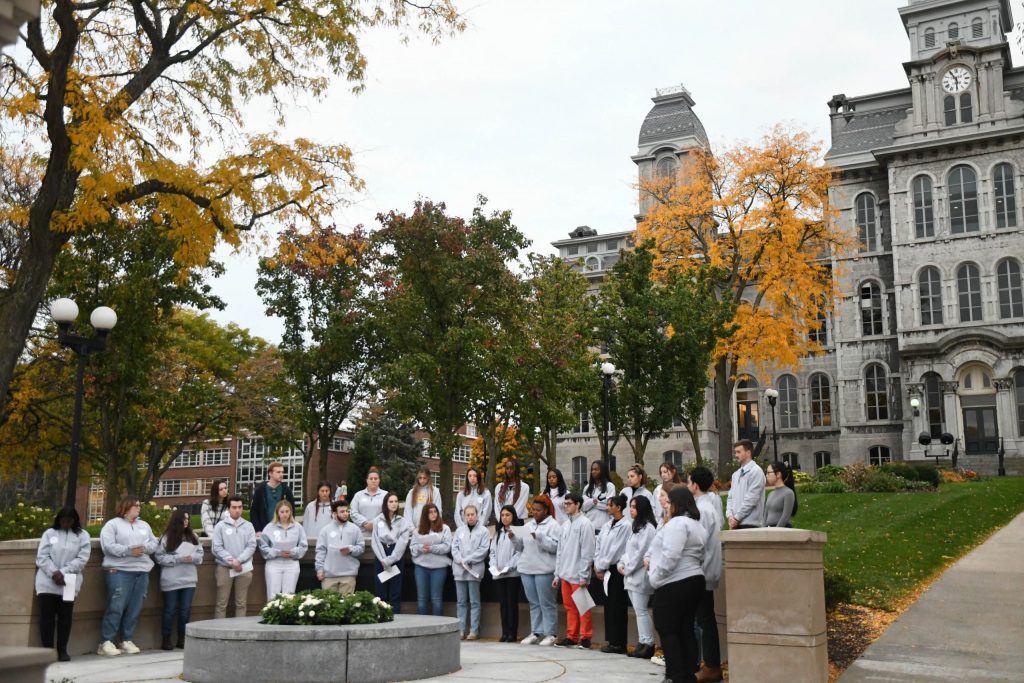 Remembrance and Lockerbie Scholars stand around the Place of Remembrance for the Candleight Vigil on Sunday, October 16, 2022.(Photo by Julia Virnelli)