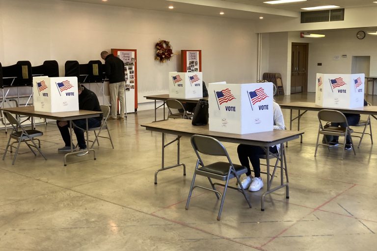 Voters fill in ballots at the Pebble Hill Presbyterian Church polling station in DeWitt for Midterm Election Day 2022