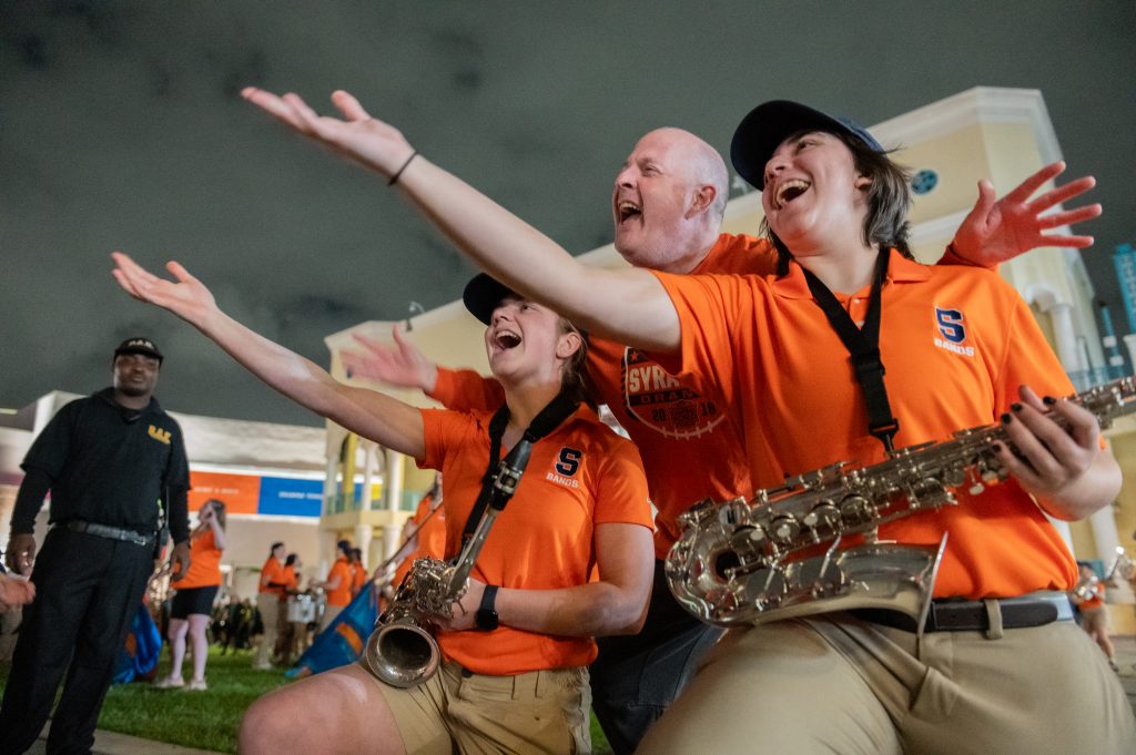 In a show of true Syracuse Orange spirit, an excited SU fan gleefully jumps in on the band's performance, demonstrating the infectious energy and camaraderie that binds the Syracuse community together, Wednesday, December 20.