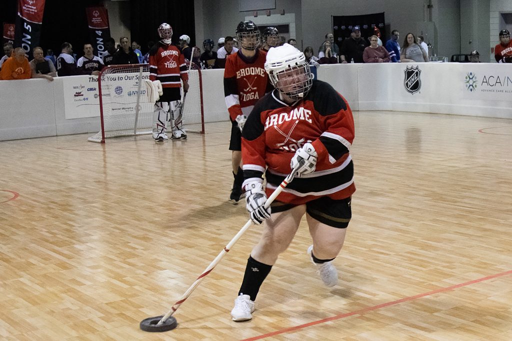 A Broome Tioga player charges up the floor during a division one floor hockey match at the Special Olympics New York Winter Games on Saturday, Feb. 25, 2023, at the Oncenter in Syracuse, N.Y.