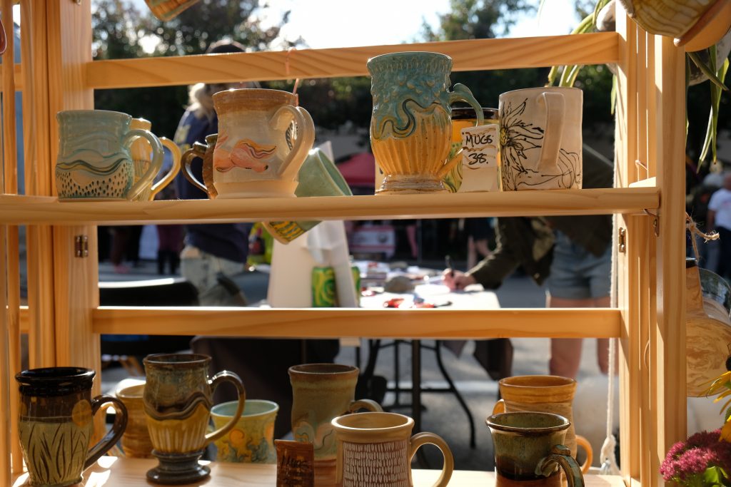 An array of pottery mugs are offered at one of the tents at the Westcott Cultural Fair on October 1, 2023.