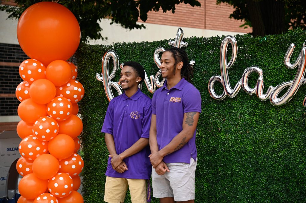 Students pose in front of 'first day' balloons outside of the Schine Student Center, on Monday, August 28.