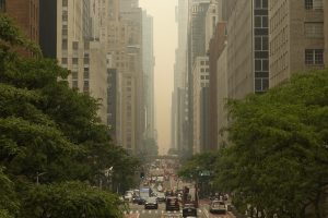 Heavy smoke from Canada wildfires turns the sky yellow as cars drive on 42nd Street on June 7, 2023 in New York City.