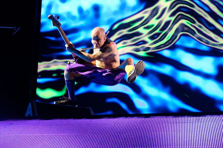 Bassist Flea jump during the Red Hot Chili Peppers concert on Friday, April 14, at the JMA Wireless Dome at Syracuse University.