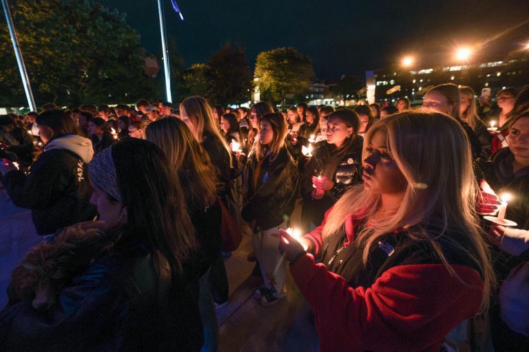 Members of the Phi Kappa Psi fraternity and the Kappa Kappa Gamma sorority participate in a candlelight vigil for Hunter Watson and Vincent Marguerie on Hendricks Chapel at Syracuse University, Monday, 16 Oct, 2023.
