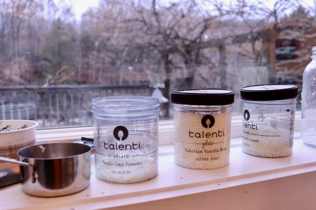 Beeswax-based paint pellets stored in Talenti gelato containers resting on the windowsill of Sally Hootnick’s art studio.