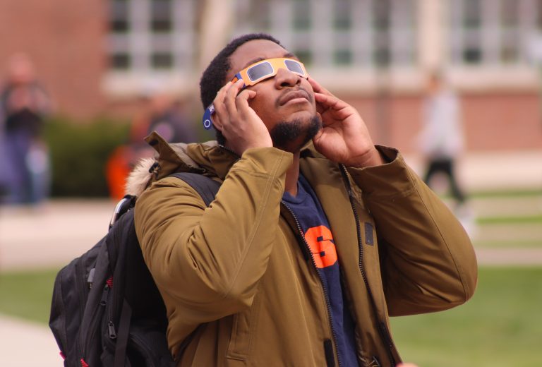 Syracuse University students gather at the Shaw Quad on campus to watch the total solar eclipse on Monday, April 8.