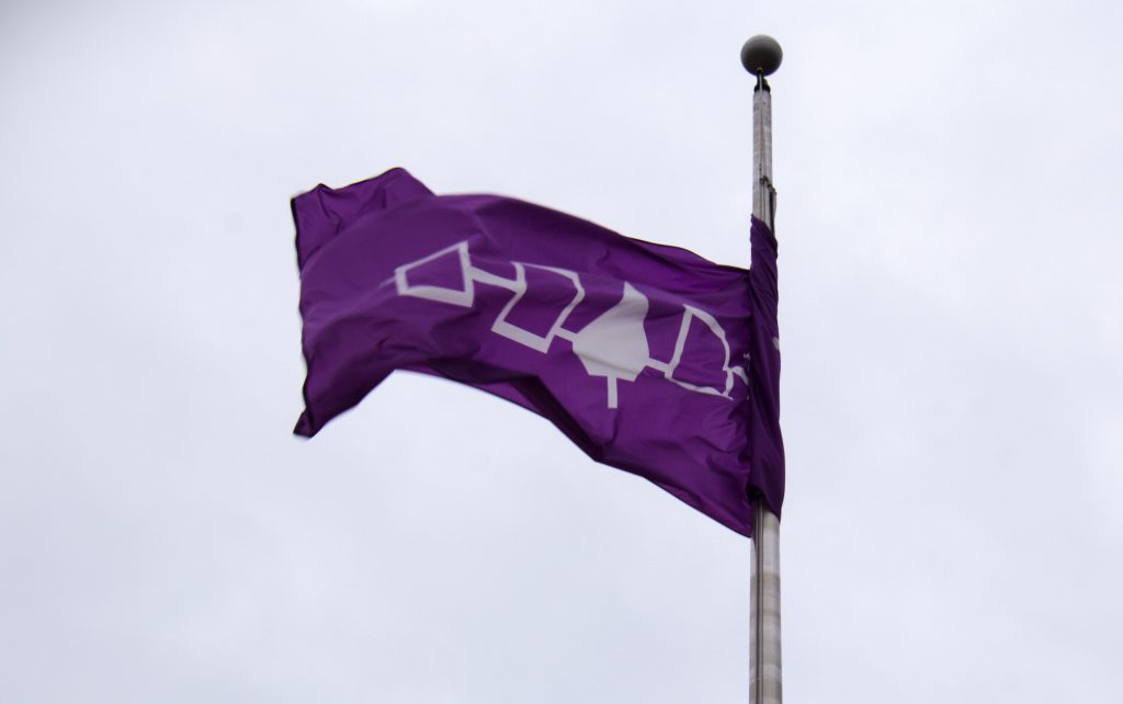 The purple and white flag that represents the Onondaga Nation community in Central New York