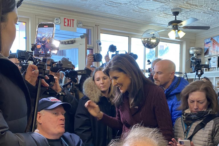 Nikki Haley stands in the crowded Robie's Country Store speaking with a voter in Hooksett, New Hampshire.
