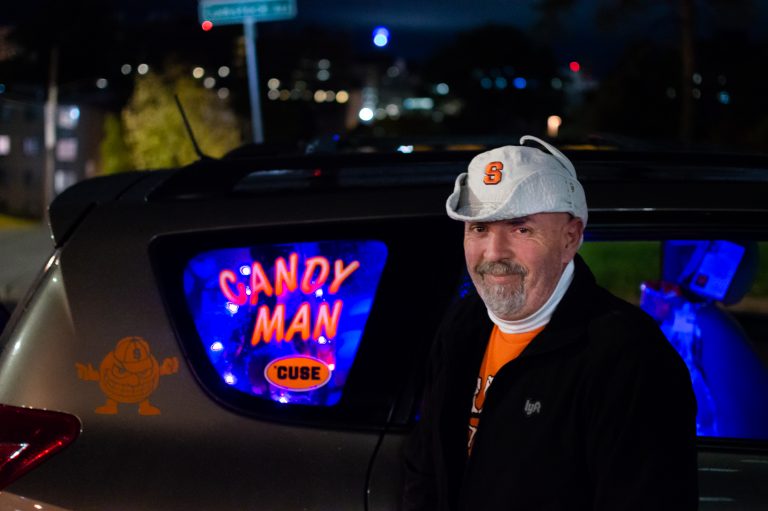 The Syracuse Candyman, Troy Boyer, stands on the corner of Comestock Avenue and Marshall Street near SU's campus.