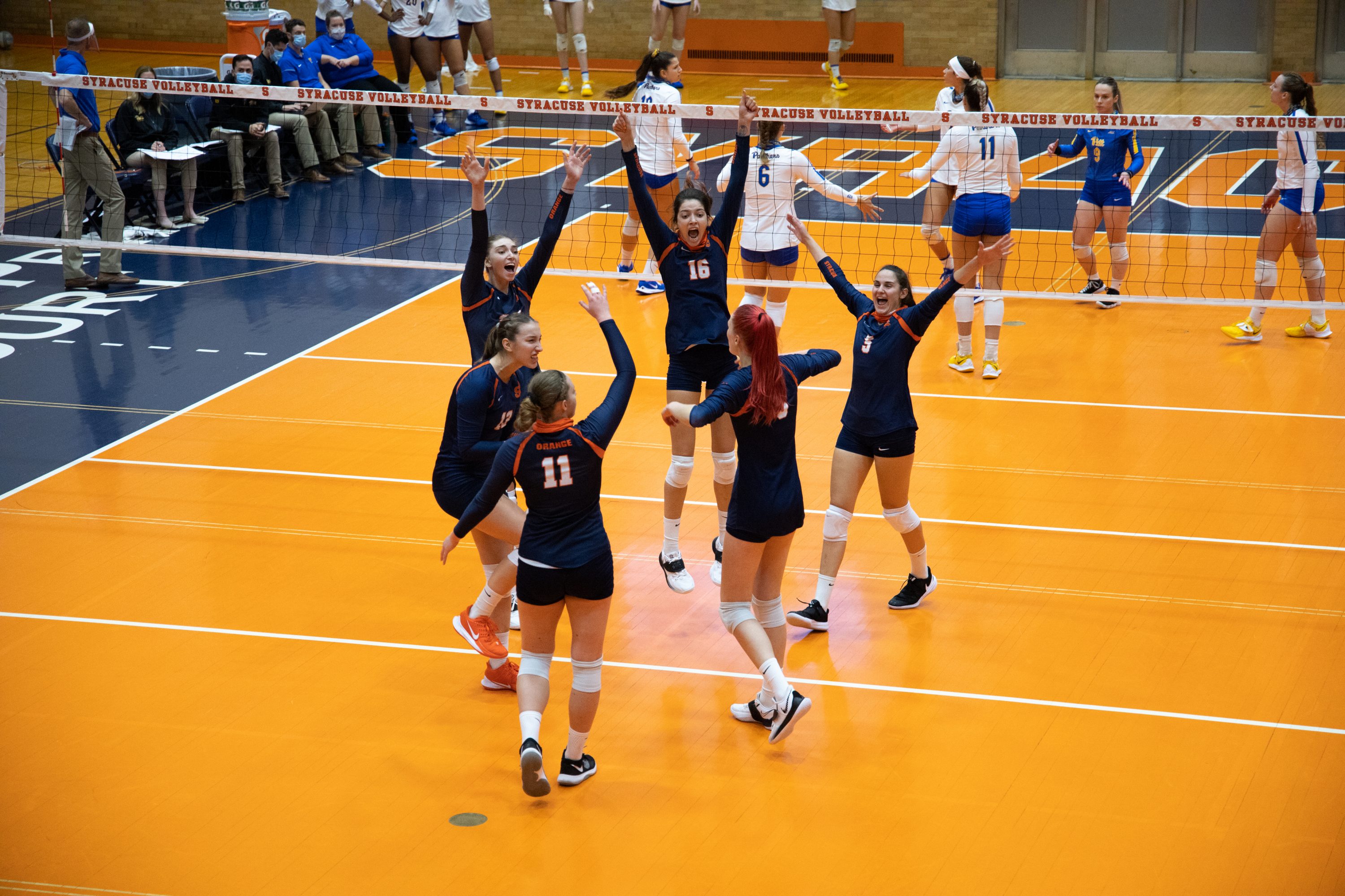 The Syracuse volleyball team celebrates after scoring a point against Pitt during their three-set win on Saturday.