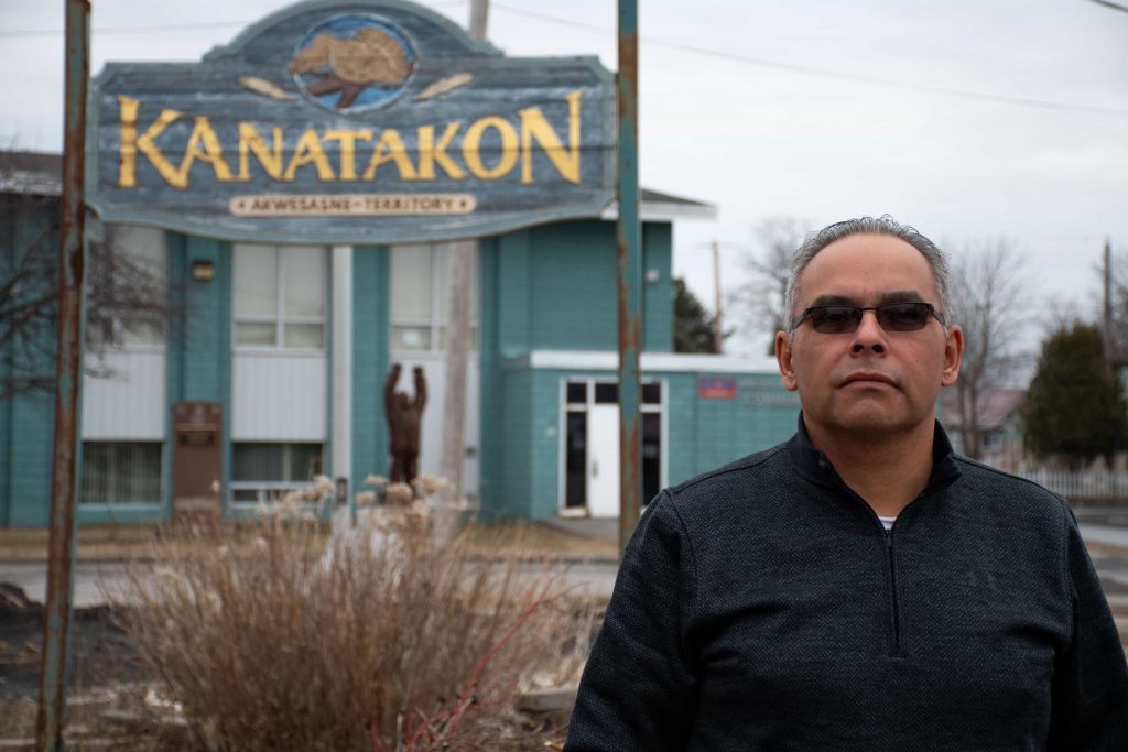 Darryl Lazore, a chief of the Mohawk Council of Akwesasne, stands on the unofficial border between the Canadian and American Akwesasne border. The only sign of the sudden switch between territories is the change from miles to kilometers on speed limit signs along the road.