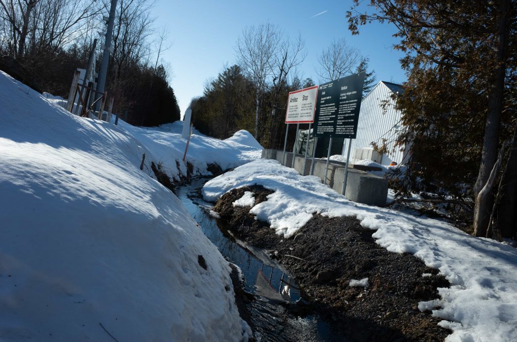 A long ditch marks the border between the United States and Canada at Roxham Road.