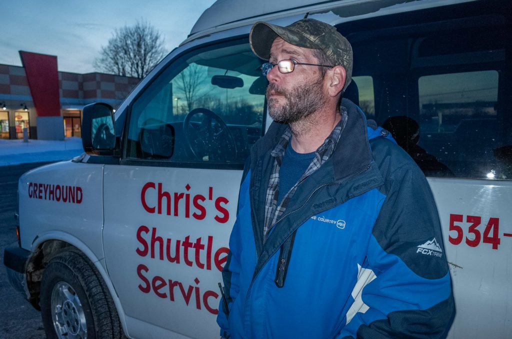 George Ero waits for a Greyhound bus to arrive in Plattsburgh, NY on March 1. Ero works for a taxi company and greets any asylum seekers as they hop off the bus, ferrying them the rest of the way to Roxham Road.
