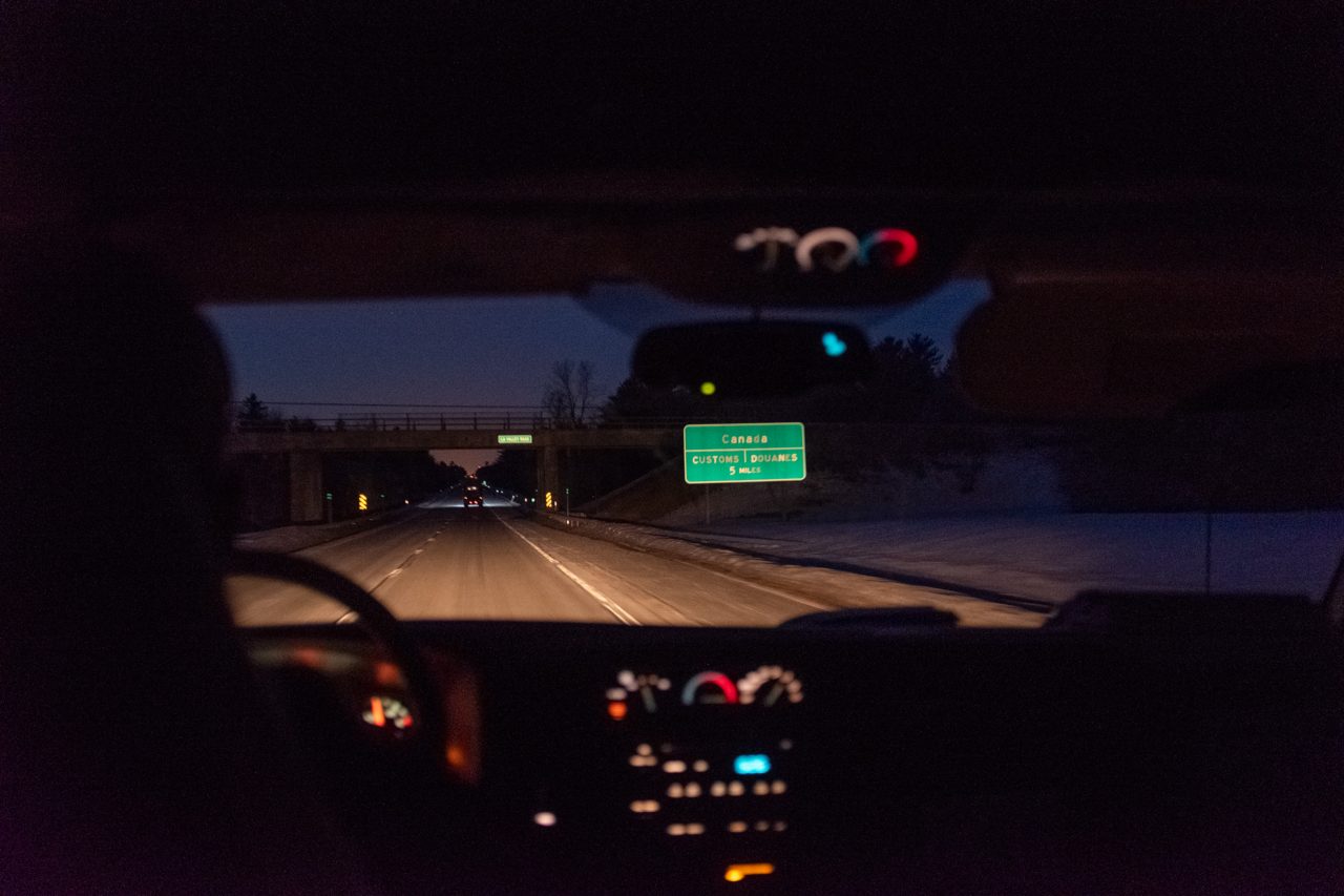 Ero drives towards the Canadian border at nightfall with a man from Tanzania in the back. “No one ever tips,” he says.