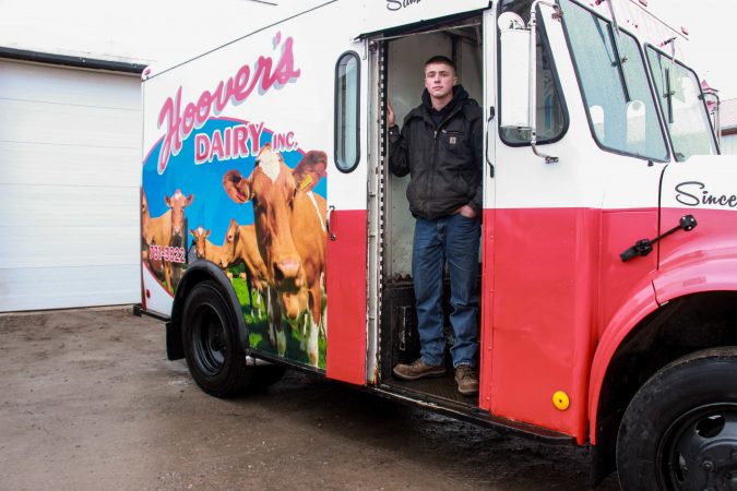 Robbie Hoover, 19, delivers glass bottles of milk twice daily, three days a week, from his family’s farm in Sanborn, N.Y.; he plans to fill his father’s shoes at Hoover's Dairy farm and continue to diversify operations.