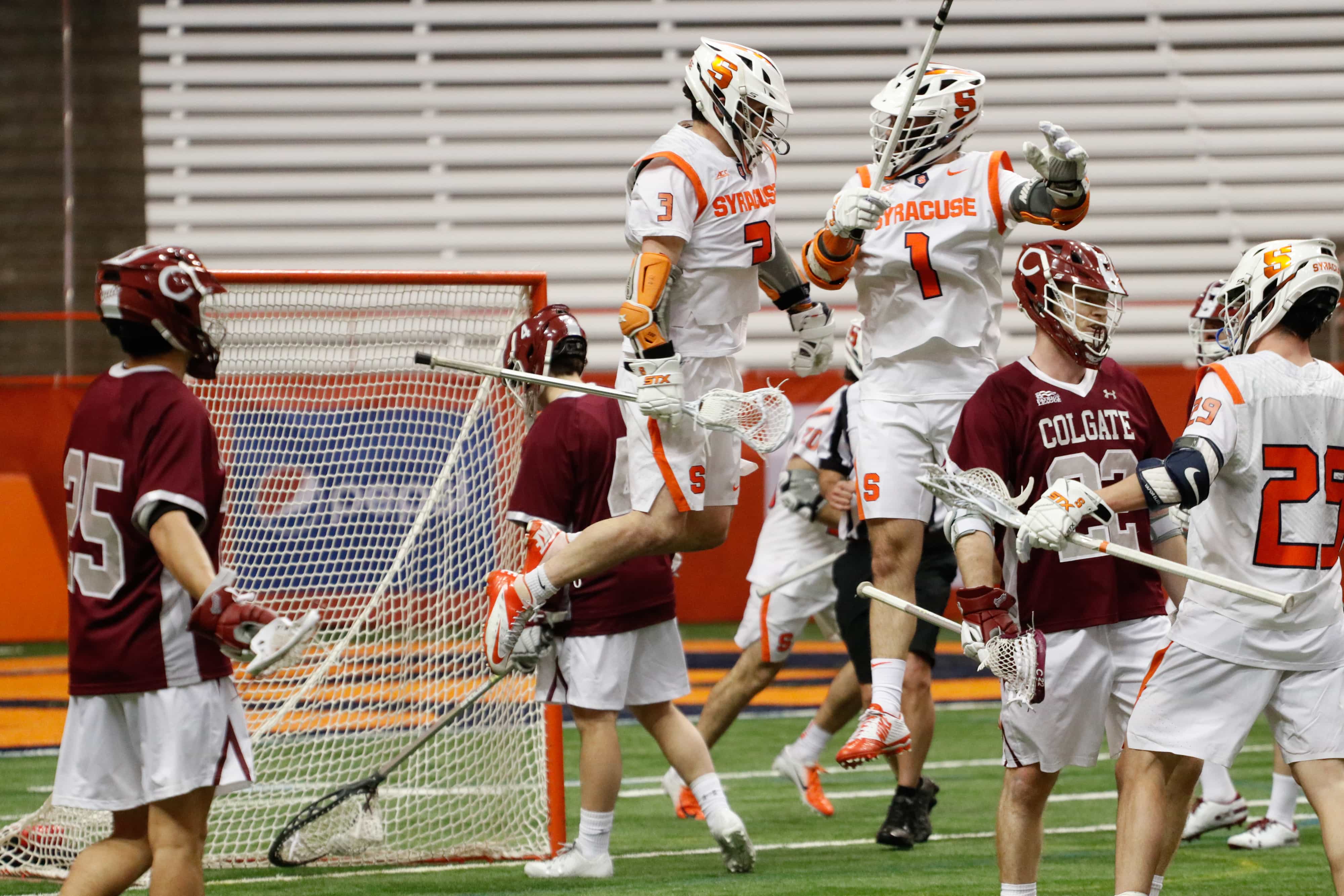 Bradley Voigt and Nate Solomon celebrate after scoring a goal against Colgate in the 2019 season opener in the Carrier Dome.