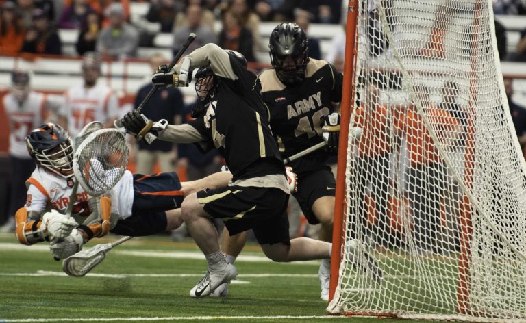 Senior Nate Solomon scores a diving goal in SU's 10-8 win over Army.