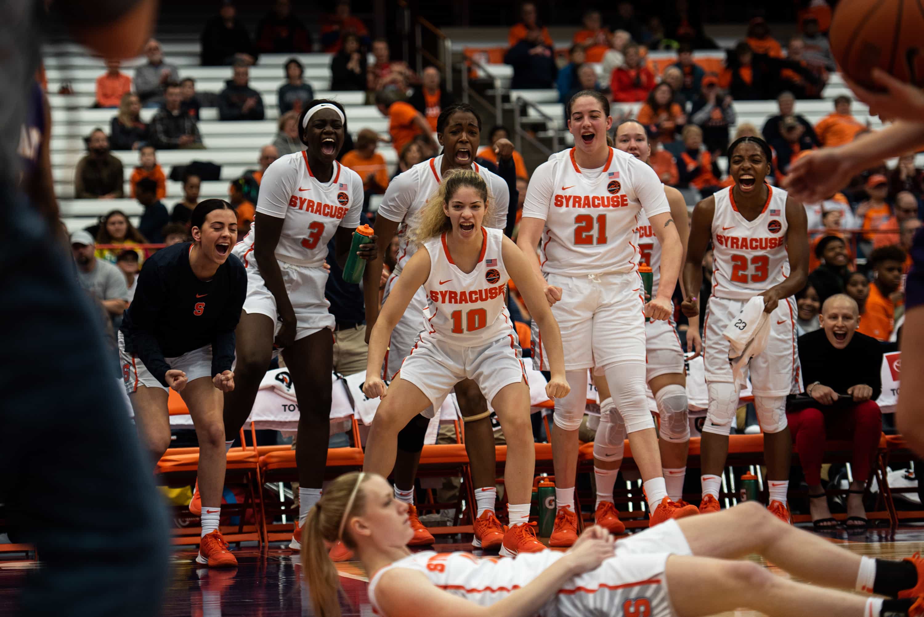 Syracuse cheers after Brooke Alexander scores a layup and draws a foul. Alexander hit her free-throw, making it a three-point play.