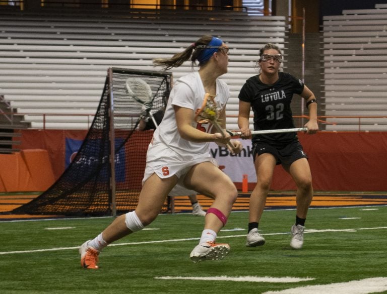 Syracuse’s Emily Hawryschuk takes on Loyola Maryland defender Katie Detwiler.