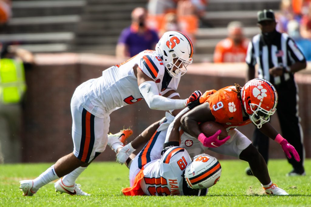 Clemson running back Travis Etienne(9) is tackled by Syracuse linebacker Geoff Cantin-Arku(31) and Syracuse defensive back Rob Hanna(19) during their game, Oct 24, 2020; Clemson, South Carolina, USA; at Memorial Stadium. Mandatory Credit: Ken Ruinard-USA TODAY Sports