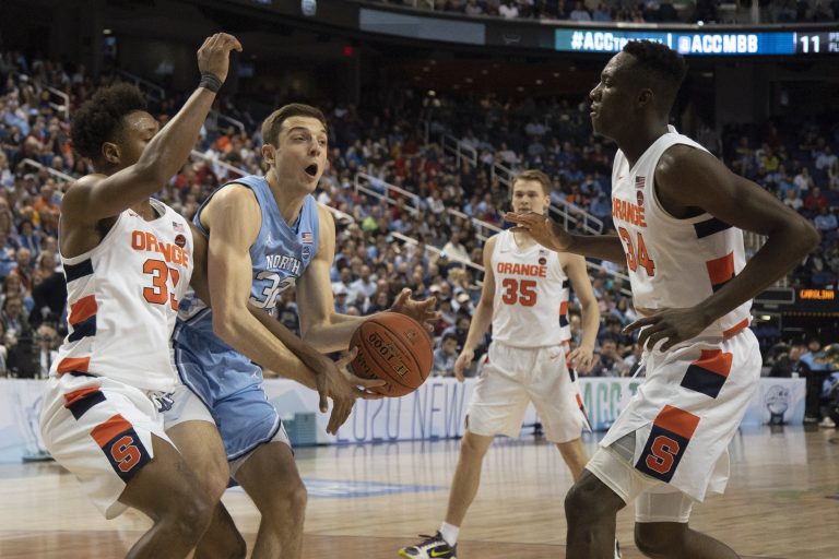 UNC graduate forward Justin Pierce (32) fights for possession of the ball against Syracuse in the second round of the 2020 New York Life ACC Tournament held in the Greensboro Coliseum in Greensboro, N.C., on Wednesday, March 11, 2020. UNC lost 81-53.