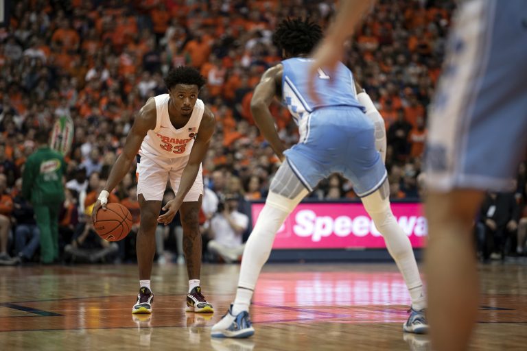 Syracuse's Elijah Hughes prepares to make a drive while covered by North Carolina #1 Leaky Black.