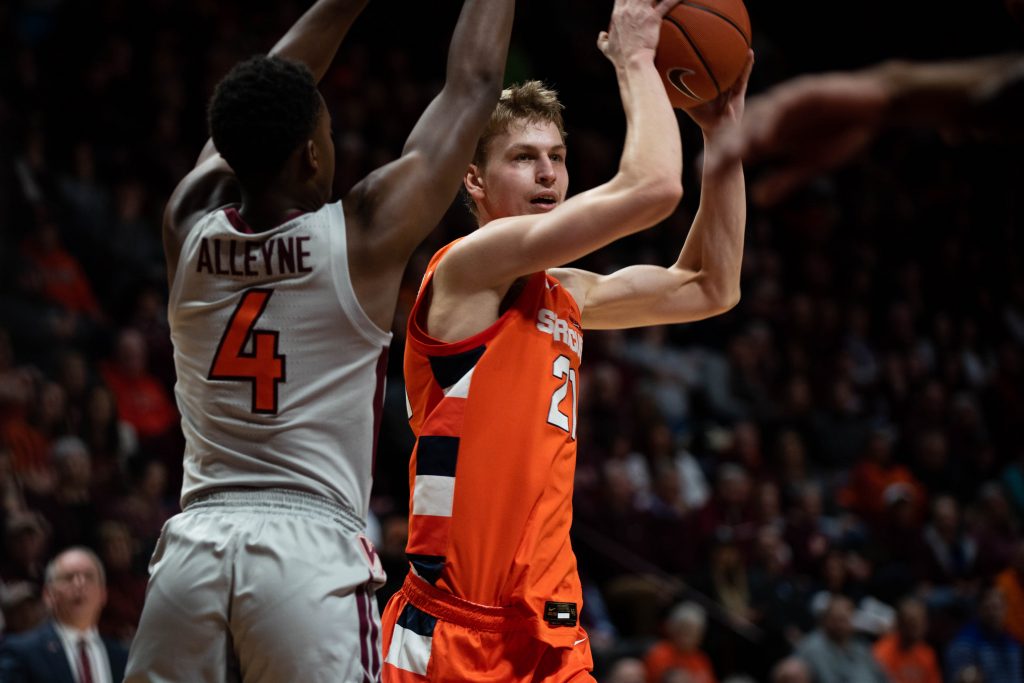 Syracuse's Marek Dolezaj (21) looks for a pass while Nahiem Alleyne (4) of Virginia Tech defends on Jan. 18 in Blacksburg, Va.