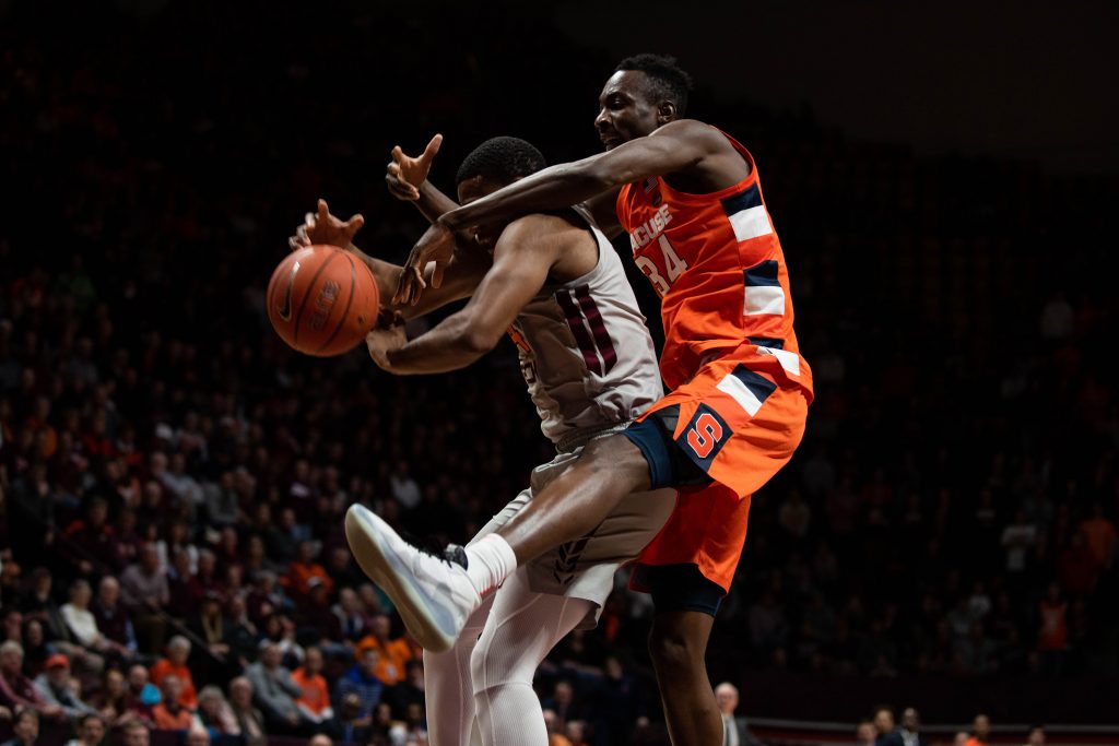 Nahiem Alleyne (4) grabs the rebound from Bourama Sidibe (34) on Jan. 18, 2020 in Blacksburg, Va.