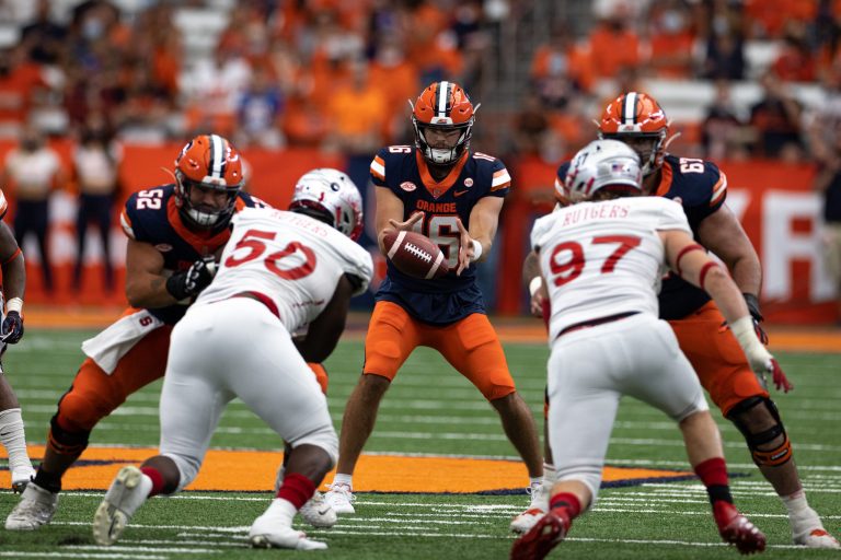 Syracuse’s Garrett Schrader (16) takes a snap under center during an NCAA football game against Rutgers, Saturday, at the Carrier Dome.