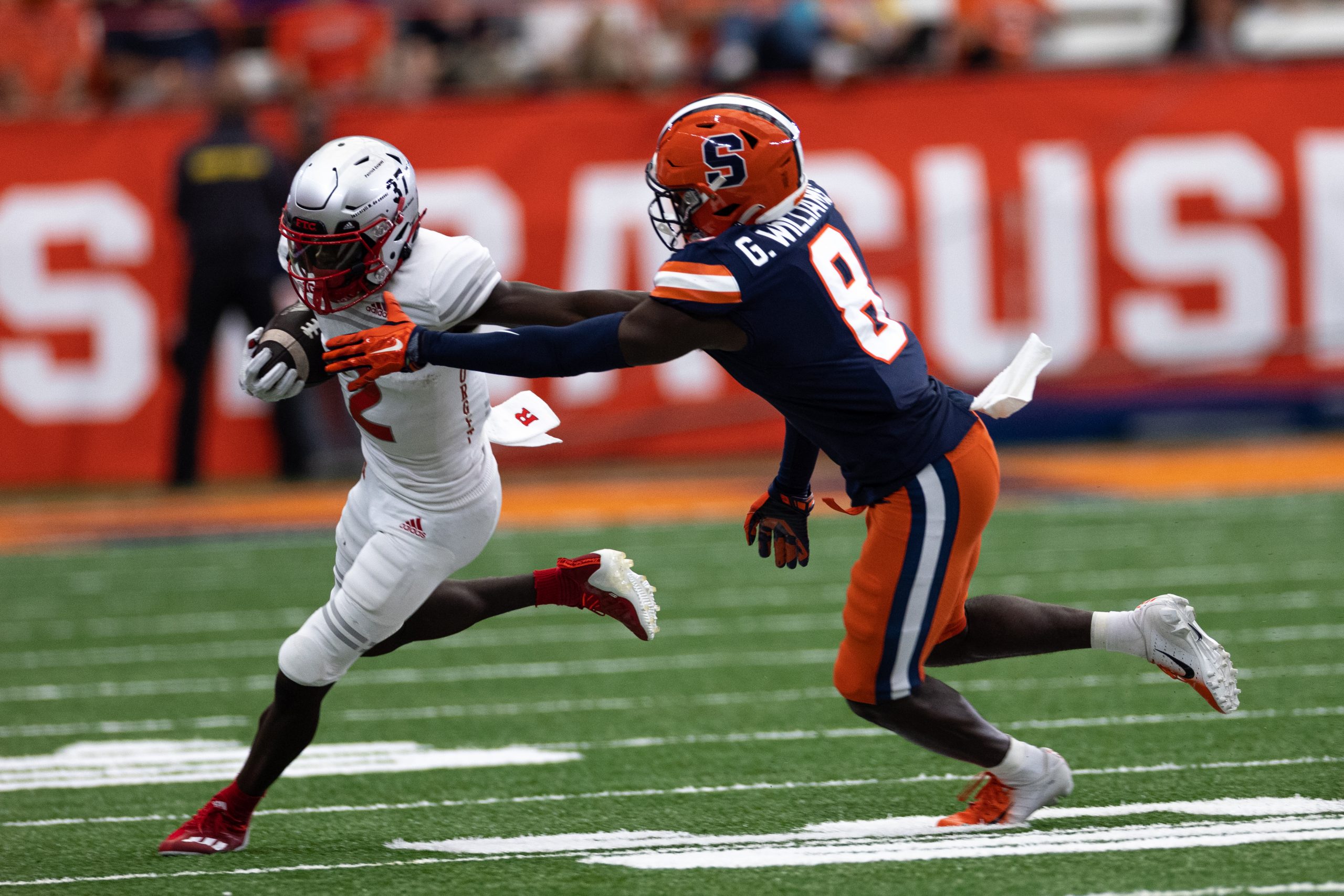 Syracuse’s Garrett Williams (8) tries to wrap up Rutgers’ Aron Cruickshank after he made a catch during an NCAA football game, Saturday, at the Carrier Dome.