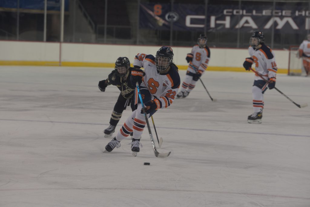 Jessica DiGirolamo (22) collects the puck and skates it into the Lions zone during a game against Lindenwood in the CHA Tournament on Mar. 4, 2021.