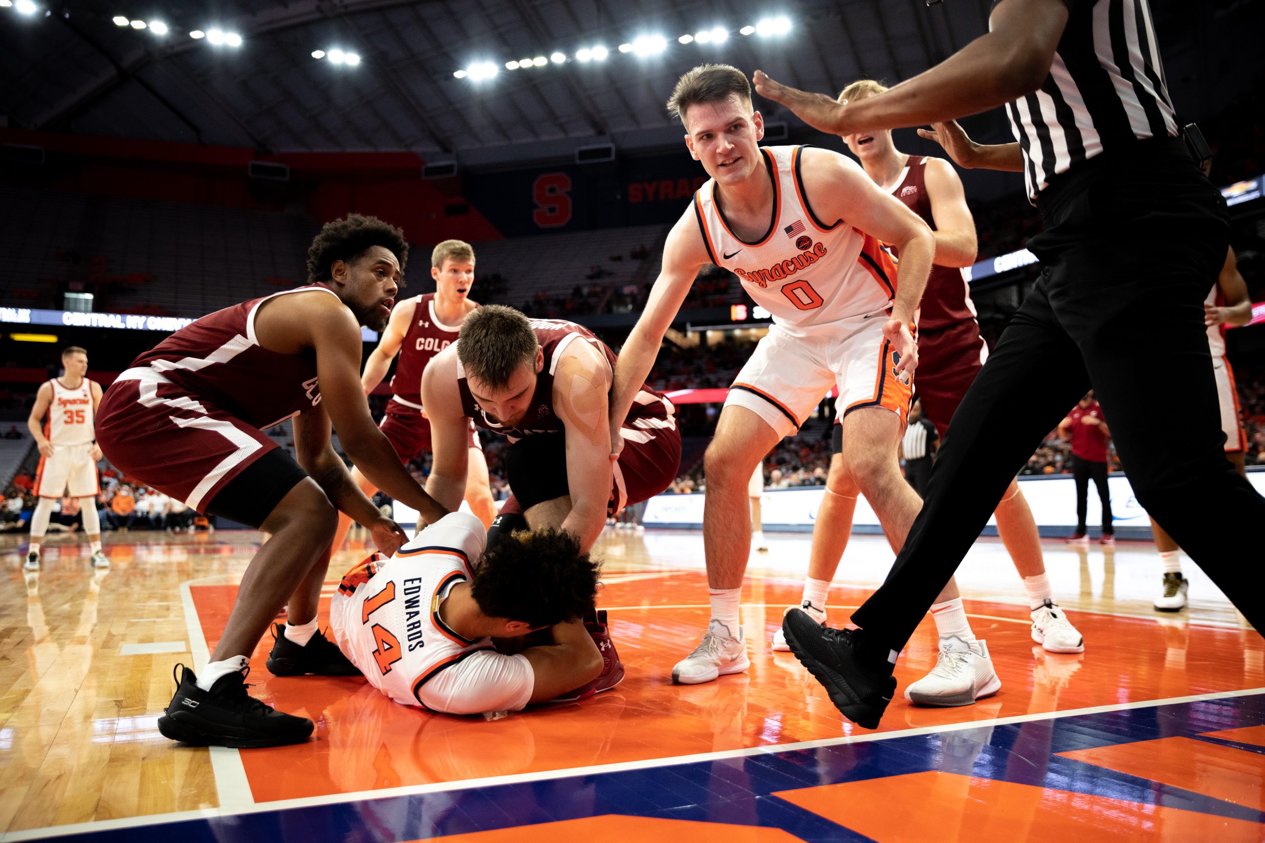 Jessie Edwards fends off Colgate players whiile Jimmy Boeheim watches on in the Orange's Nov. 20, 2021, loss in the Dome.