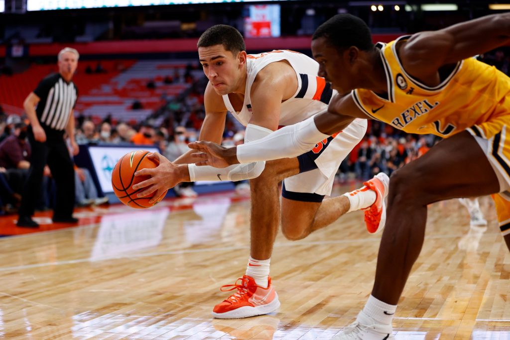 Syracuse's Cole Swider grasps a loose ball ahead of Drexel's Amari Williams in Syracuse's win.