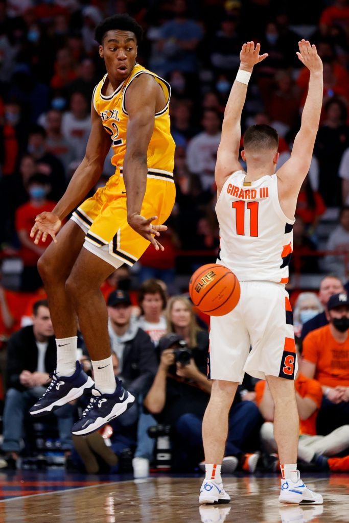 Drexel's Amari Williams twists in the air to lay a bounce pass past Joe Girard.