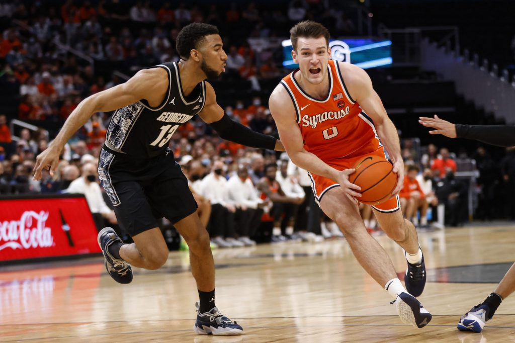 Syracuse's Jimmy Boeheim (0) drives through the lane against Georgetown's Donald Carey during an ACC men's basketball game on Saturday at Capital One Arena.