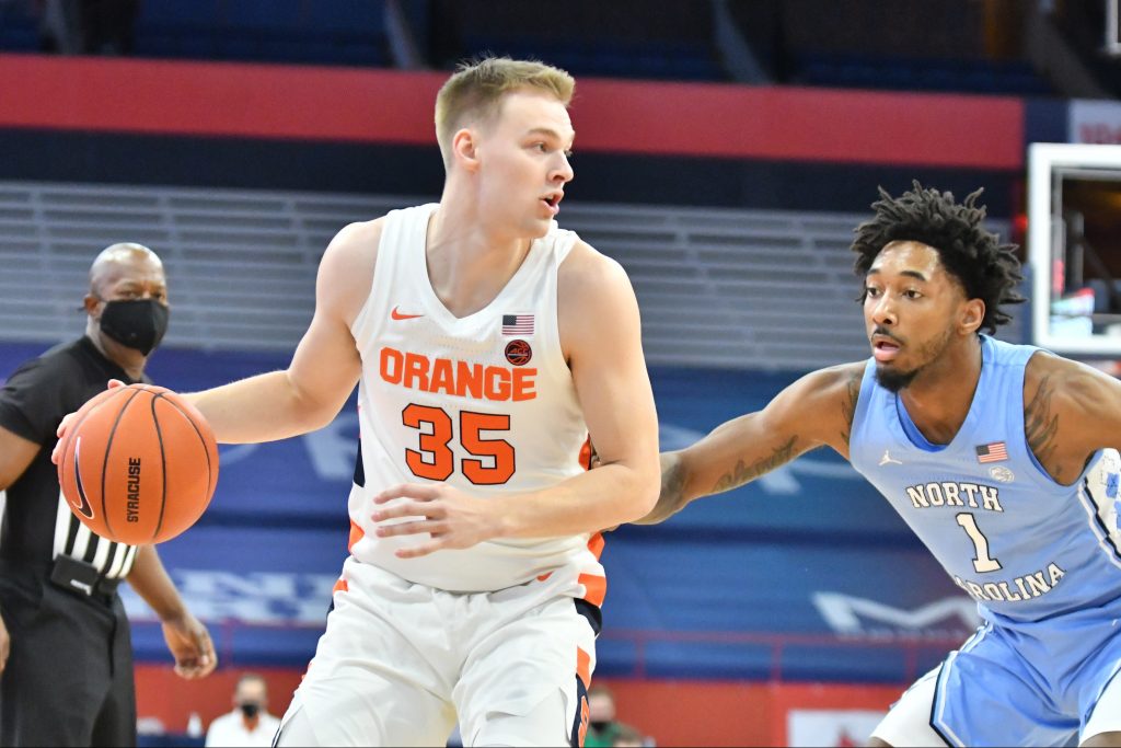 Mar 1, 2021; Syracuse, New York, USA; Syracuse Orange guard Buddy Boeheim (35) tries to get the ball past North Carolina Tar Heels guard Leaky Black (1) in the first half at the Carrier Dome. Mandatory Credit: Mark Konezny-USA TODAY Sports