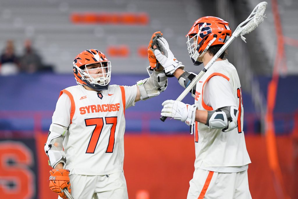 Owen Hiltz #77 of the Syracuse Orange celebrates a goal with teammate Owen Seebold #14 against the Robert Morris Colonials during the second half at the Carrier Dome.