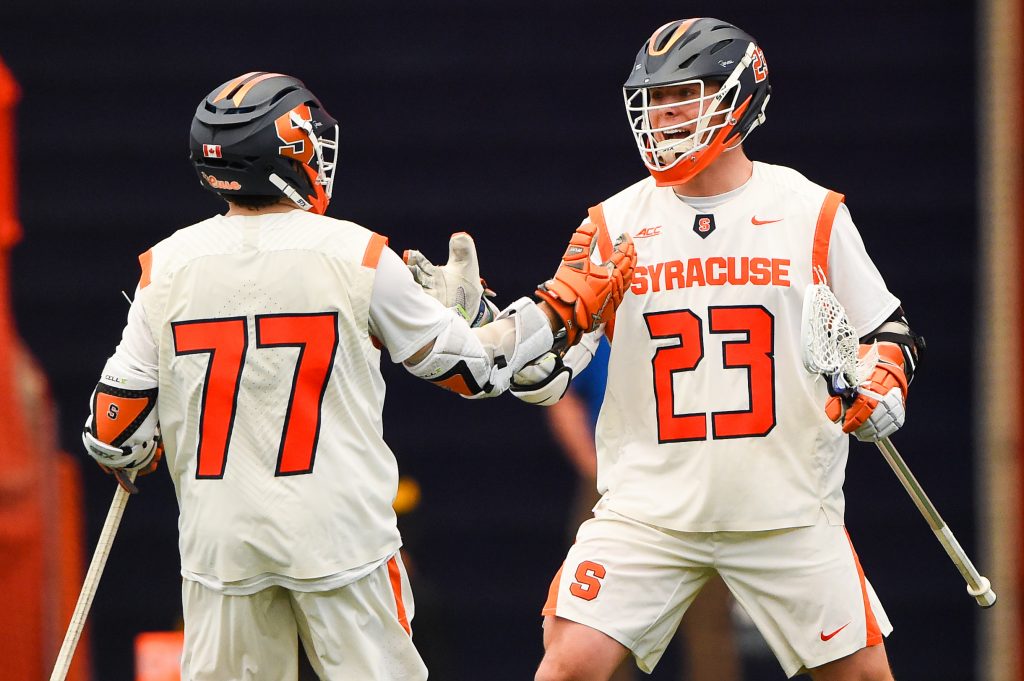 Mar 12, 2021; Syracuse, New York, USA; Syracuse Orange attackman Owen Hiltz (77) and midfielder Tucker Dordevic (23) celebrate a goal against the Stony Brook Seawolves during the first half at the Carrier Dome. Mandatory Credit: Rich Barnes