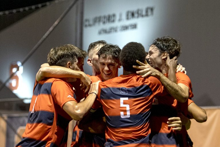 The Syracuse men's soccer team celebrates after junior defenseman Christian Curti's goal during its season opener against Drexel at the SU Soccer Stadium, August 26.