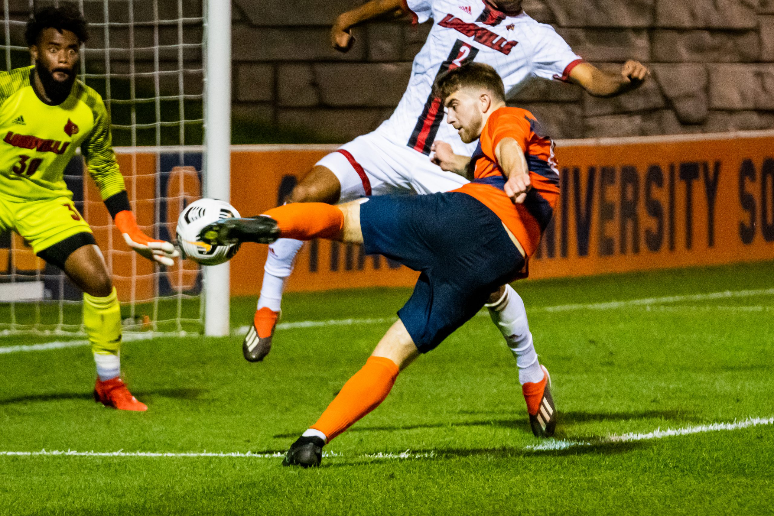 Syracuse's Giona Leibold strikes a shot with his left foot toward the goal and Louisville keeper Detre Bell, as Louisville's Dante Huckby (2) tries to deflect, during a men's soccer game, Friday, in Syracuse.