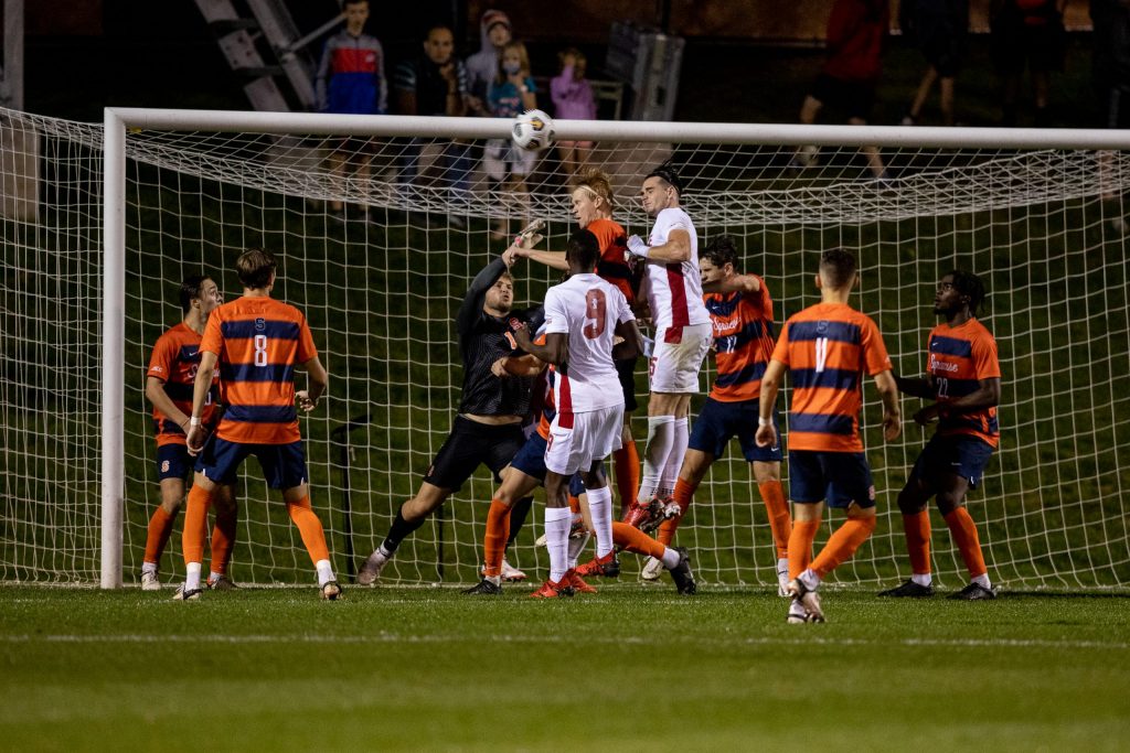 Syracuse goalie Russel Shealy challenges for the ball over teammates and foes in Syracuse's 0-0 draw with NC State on Friday.