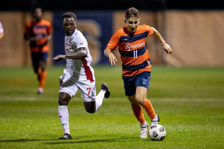 Syracuse Men's Soccer midfielder Hilli Goldhar drives past a NC State player in the 0-0 draw on Friday night.