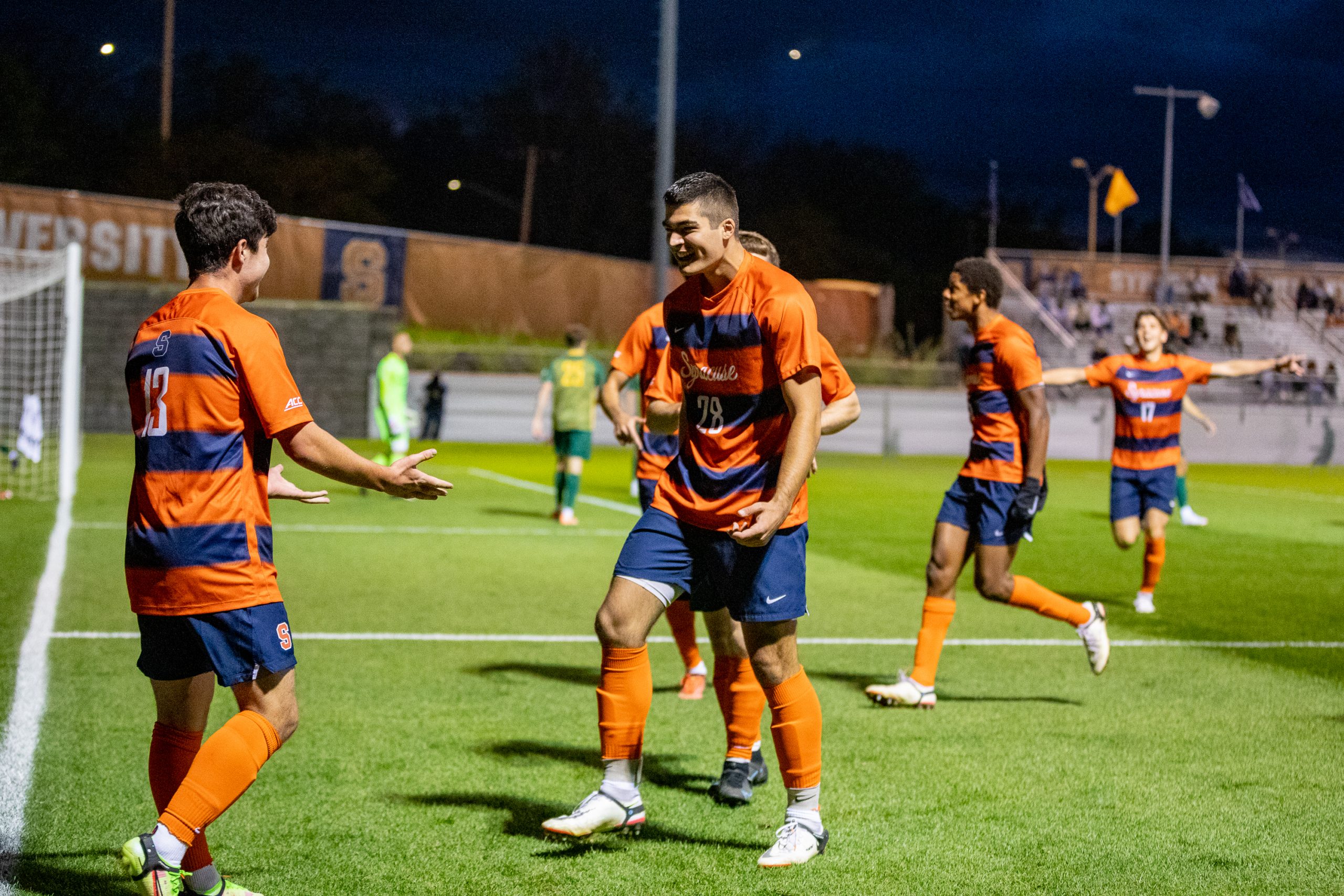 Colin Biros (13) celebrates with his teammates after scoring Syracuse's first goal during the Syracuse University Men's Soccer game vs UVM.