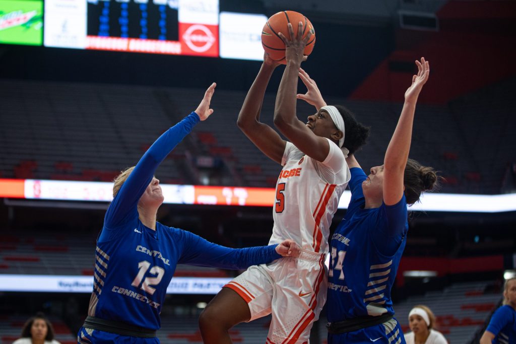 Syracuse's Teisha Hyman (5) elevates above two Central Connecticut State defenders for a bucket in their huge win on Sunday at The Dome.