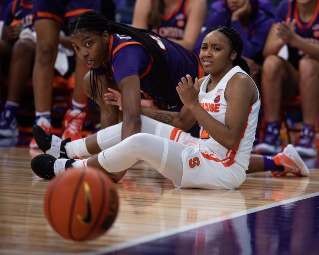 Syracuse's Chrislyn Carr (32) looks in disgust after former Syracuse, now Clemson Tiger, Kiara Lewis (23) knocks the ball away from her on Saturday.