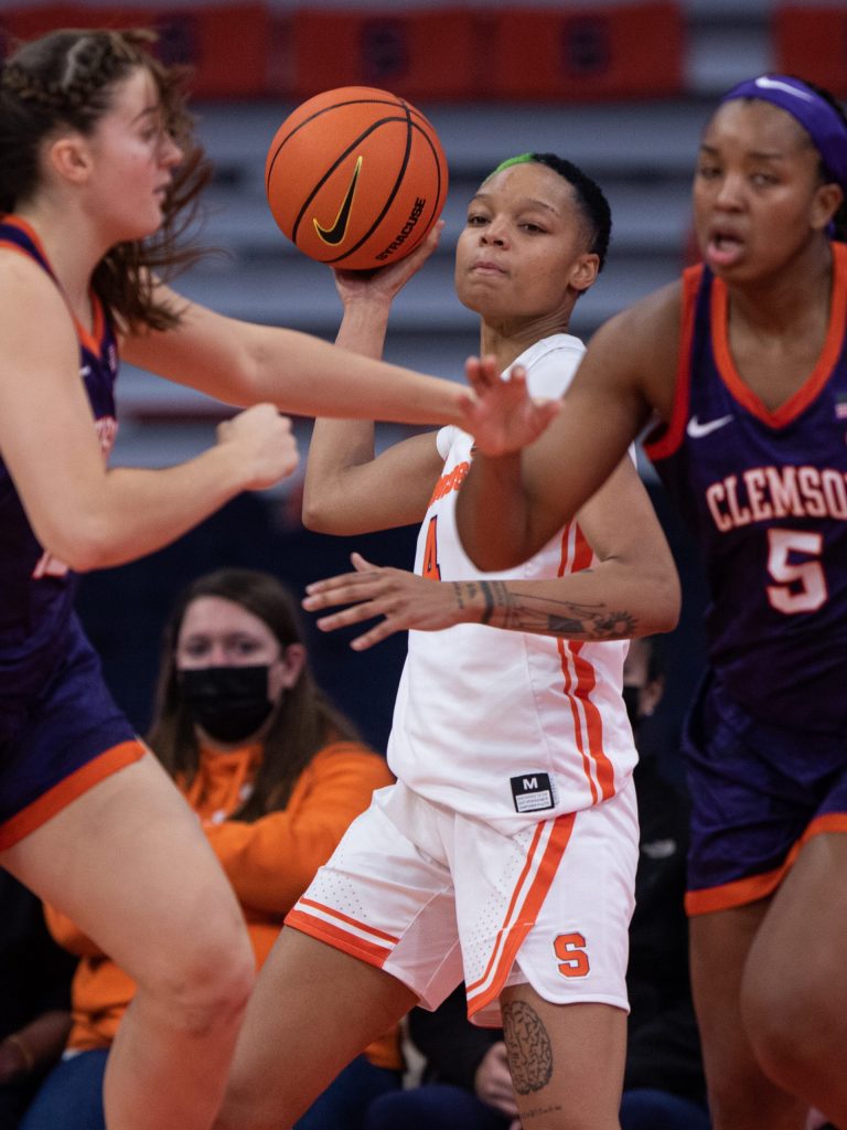 SU's Alaysia Styles (5) winds up for a football pass over the Clemson defense following a rebound on Saturday night.